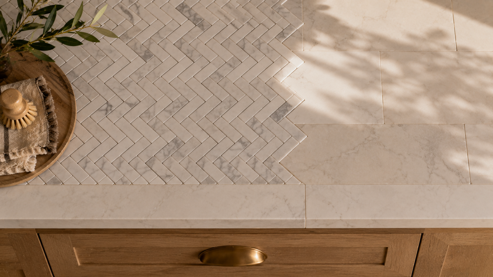BASINCRAFT natural stone mosaic and tile collection — herringbone and hexagon patterns in marble and travertine