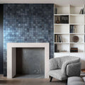 Elegant distressed marble mosaic fireplace feature with minimalist design and natural stone craftsmanship.