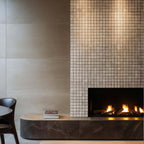 Stylish fireplace featuring a travertine mosaic wall and minimalist design, showcasing natural stone craftsmanship.