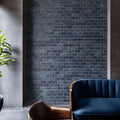 Elegant black marble wall with distressed mosaic finish, enhancing minimalist interior design.