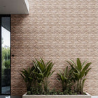 Travertine blasted brick mosaic wall with lush green plants, showcasing premium natural stone's elegance.