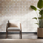 Stylish chair in front of a travertine mosaic wall; perfect for minimalist interiors and natural stone elegance.