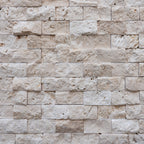 Blasted travertine wall tiles showcasing natural stone's elegant 3D texture, ideal for minimalist designs and vessel sinks.