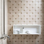 Beige marble mosaic tiles with a minimalist design in a modern shower setting featuring a white recessed shelf.