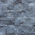 Blasted marble mosaic brick wall design, showcasing premium natural stone craftsmanship and minimalist elegance.