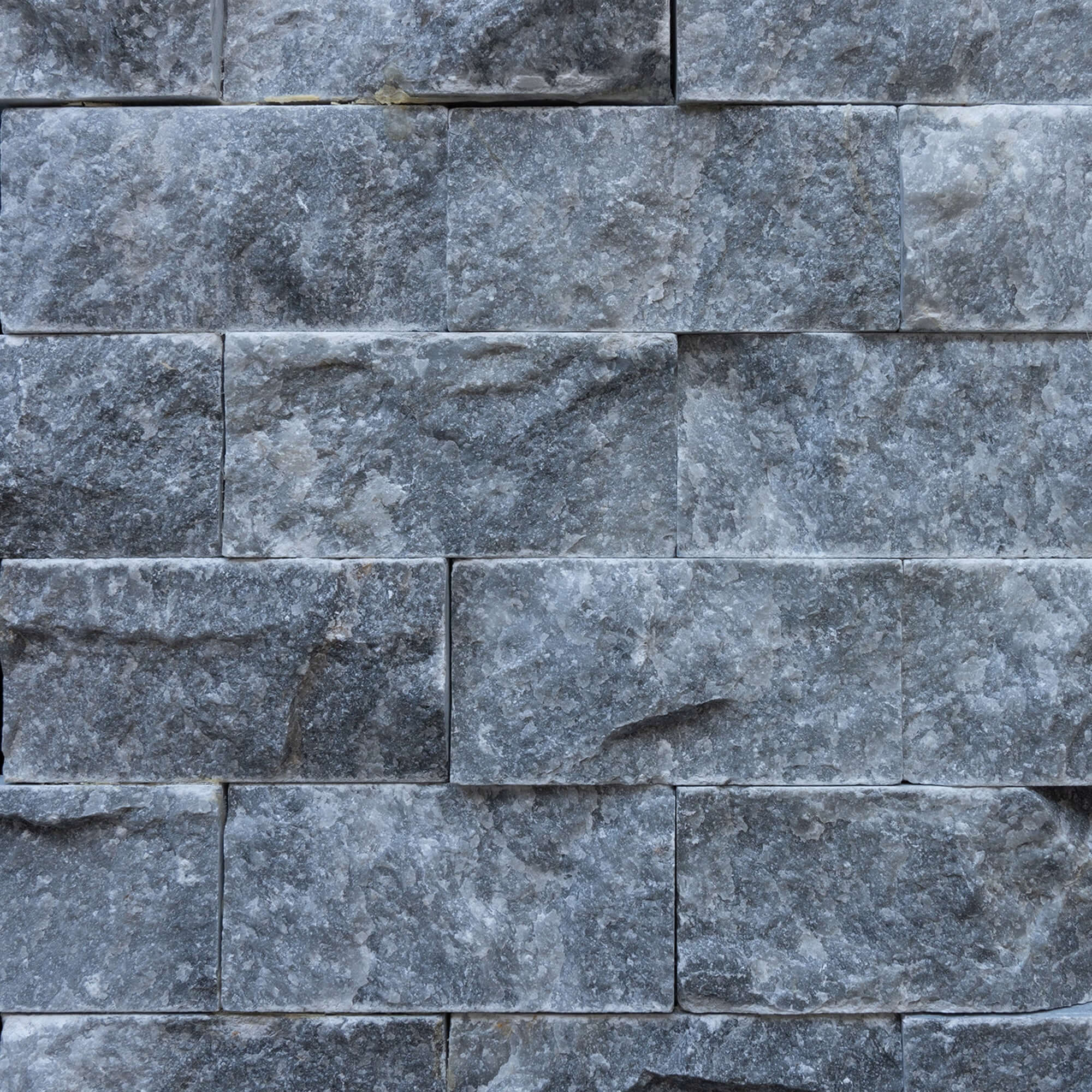 Blasted marble mosaic brick wall design, showcasing premium natural stone craftsmanship and minimalist elegance.