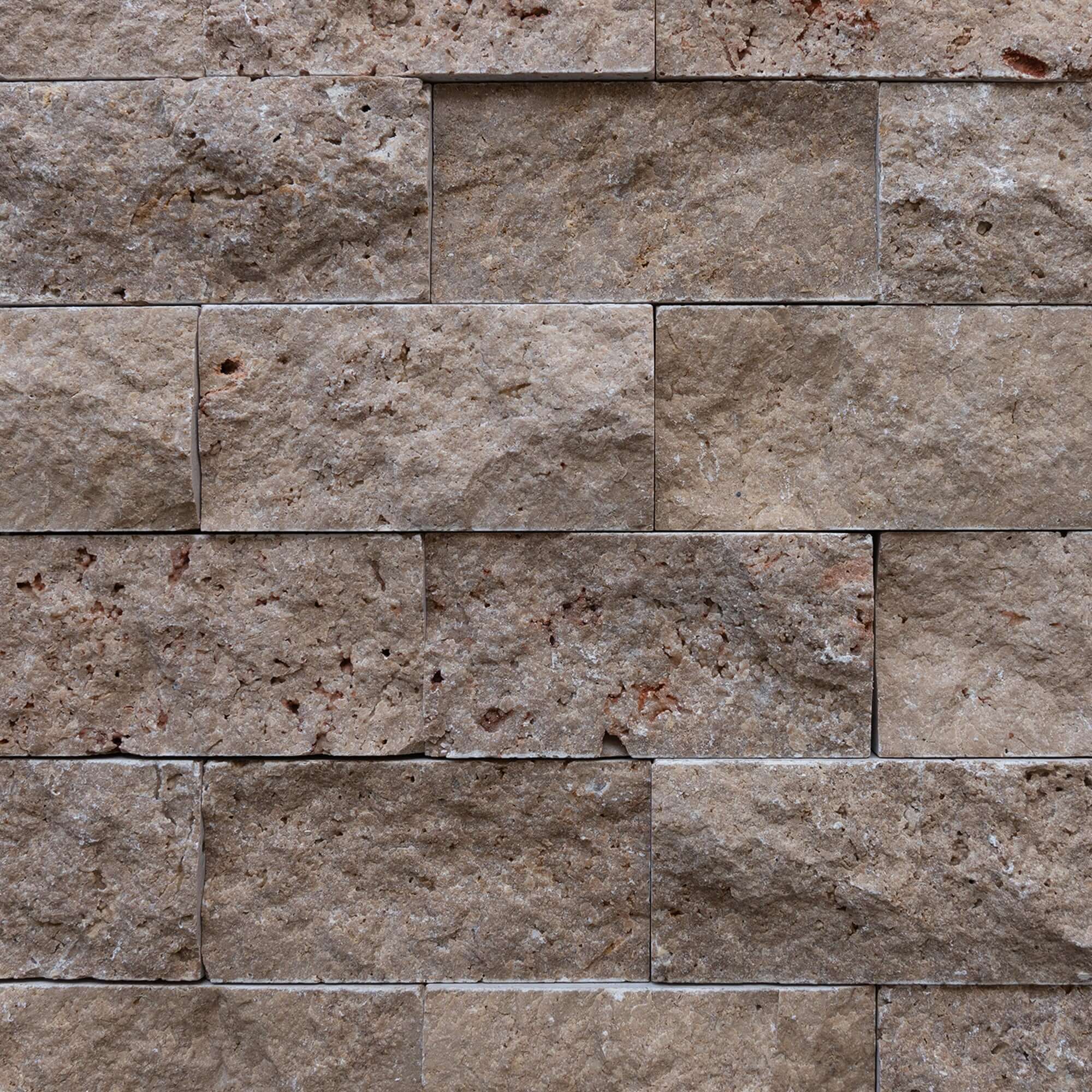 Blasted travertine brick mosaic displaying a textured, natural stone surface for premium design and lasting elegance.