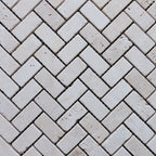 Travertine distressed mosaic tiles in a herringbone pattern, showcasing premium natural stone craftsmanship.